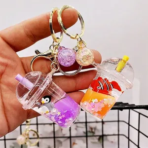 Creative milk tea cup keychains with purple penguin and orange clownfish liquid sand