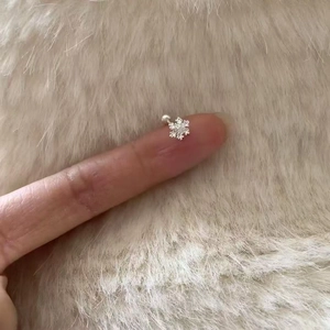 Detailed view of silver snowflake stud earring with zircon stone and screw back ball design