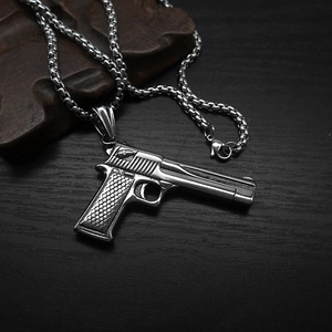 Punk style large pistol pendant necklace made of silver titanium steel on wood
