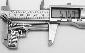 Detailed measurement of large punk desert eagle pistol pendant at 57.69mm with calipers