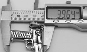 Macro shot measuring the 39.64mm large pistol pendant with a digital caliper tool