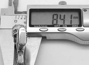 Macro view of gun pendant thickness 8.41mm measured with digital calipers