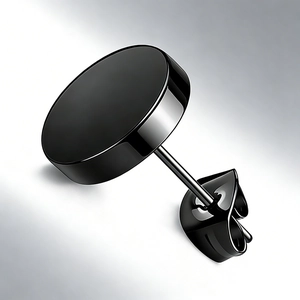 Macro view of a minimalist black round stud earring with a butterfly clutch back closure