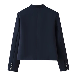 Detailed back view of dark blue blazer featuring silver embossed buttons on the cuffs