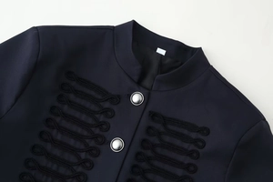 Detail of navy military jacket featuring stand collar and intricate woven rope decorations