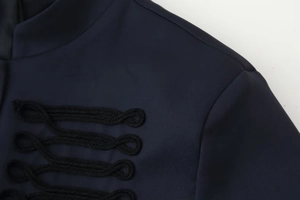 Detail of navy blue jacket featuring intricate black braided frogging and military style