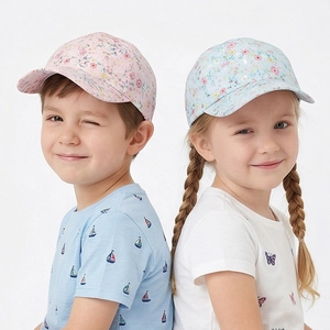 Pink and blue girls' baseball caps with floral print design shown on child models