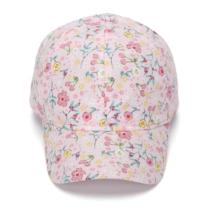 Close-up of floral print and cherry pattern on cotton pink girl's baseball cap