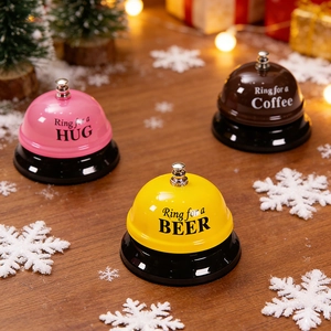 Three creative metal call bells for hug, beer, and coffee on a festive wooden desk