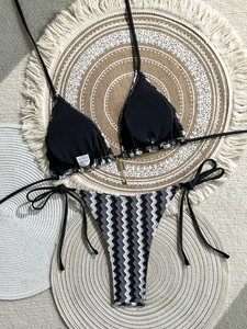 Detail of striped crochet bikini with gold chain pendant and soft knit texture