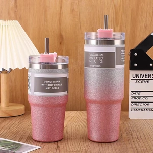 Close-up of 30oz glitter gradient pink stainless steel tumbler with straw in home setting