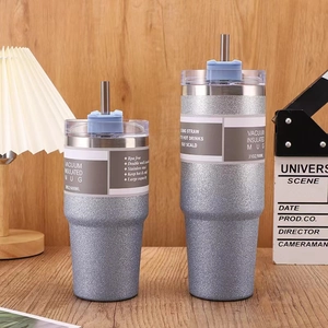 Detail of 20oz and 30oz glitter grey insulated tumblers with stainless steel straws