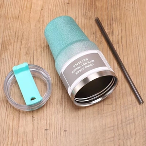 Gradient glitter 30oz stainless steel travel tumbler with lid and straw on wood floor