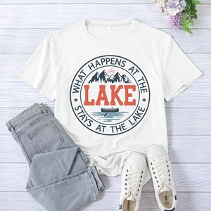 Flat lay of white T-shirt with 'What Happens at the Lake' print and blue jeans