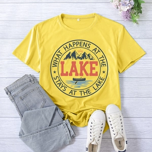 Flat lay of yellow Lake print T-shirt with denim shorts and white canvas sneakers