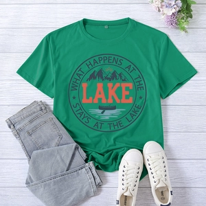 Close-up of green lake-themed t-shirt with print on a white wooden background