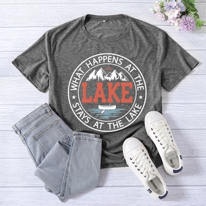 Flat lay of gray lake print t-shirt paired with denim jeans and canvas sneakers