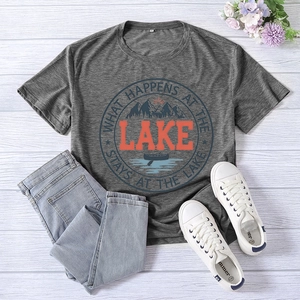 Flat lay of gray T-shirt with lake graphic print paired with jeans and sneakers
