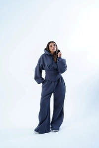 Détail de la taille à cordon sur le sweat à capuche bleu marine et pantalon large