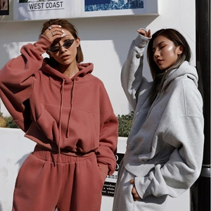 Outdoor street shot of women in oversized fleece hoodies and matching sweatpants set