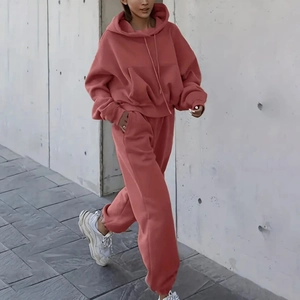 Detail of oversized brick red tracksuit with drawstring hoodie and matching sweatpants