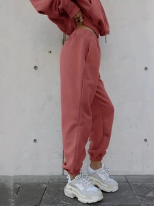 Side view of coral pink knit drawstring hoodie and high-waist joggers set