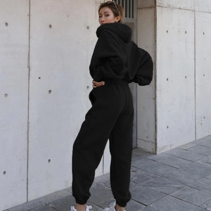 Close-up of black casual two-piece tracksuit set with hoodie and joggers from side view