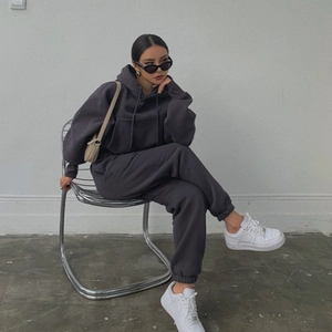 Detail of dark gray oversized fleece hoodie set with elastic cuffs and matching joggers