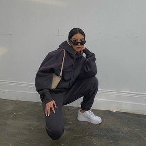 Deep grey oversized hoodie and joggers set shown in a stylish side pose with soft lighting
