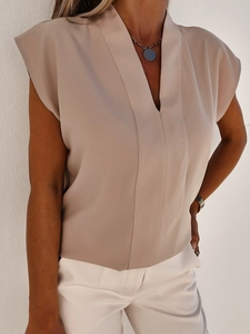 Detail der hellbeigen ärmellosen Chiffon-Bluse mit V-Ausschnitt und fließender Passform
