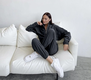 Détail d'un ensemble de survêtement gris foncé avec sweat à demi-zip et pantalon jogger