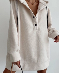 Close-up of cream fleece hoodie showing textured fabric, half-button placket and black drawstrings