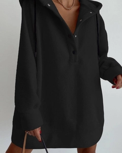 Detail view of the soft fleece fabric and buttoned neckline on this black oversized hoodie