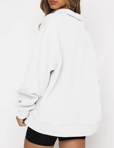 Side view of white oversized hoodie showing ribbed hem and loose casual fit on model