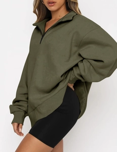 Side view of olive green oversized half-zip sweatshirt with dropped shoulders