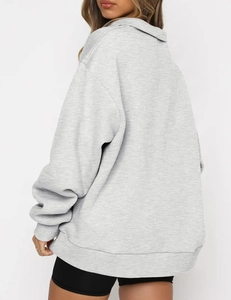 Detail of light grey oversized pullover hoodie with ribbed cuffs and drop shoulder seam