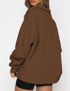 Detail view of oversized chocolate brown hoodie with ribbed cuffs and drop shoulder seam