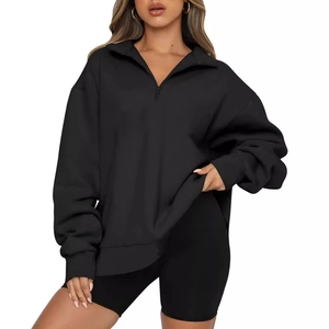 Women's black oversized quarter-zip sweatshirt with a high collar and dropped shoulders