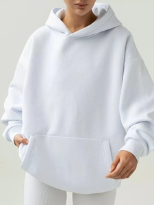 Detail view of oversized ice blue hoodie showing drop shoulders and kangaroo pocket