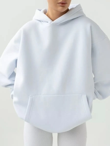 Detailed front view of light blue oversized hoodie featuring a kangaroo pocket and dropped shoulders