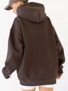 Rear view of an oversized dark brown hoodie showing drop shoulder fit and hood detail