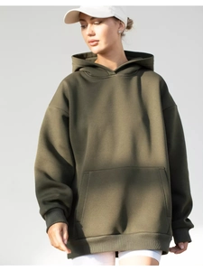 Detailed close-up of army green oversized hoodie featuring kangaroo pocket and ribbed hem