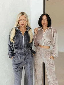 Detail of velvet tracksuit featuring ribbed cuffs and high-waist wide-leg sweatpants