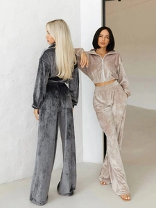 Detailed view of the luxury velvet fabric on the zip-up hoodie and wide-leg trousers