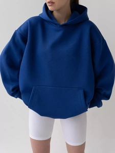 Detailed view of royal blue hoodie showing kangaroo pocket and drop shoulder seams