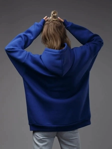 Rear view of a royal blue oversized hoodie featuring drop shoulders and ribbed cuffs