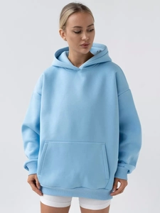 Detail view of light blue oversized hoodie featuring soft fabric and a kangaroo pocket