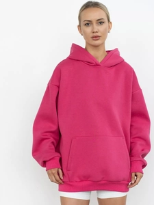 Detail view of hot pink oversized hoodie with drawstring hood and kangaroo pocket feature