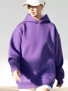 Detail view of purple oversized hoodie featuring drop shoulders and rib-knit cuffs
