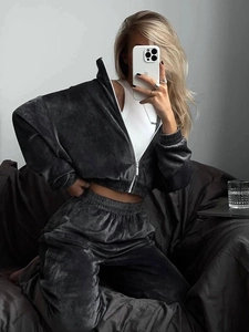 Detail of soft charcoal grey velvet fabric texture on stylish women's trackset